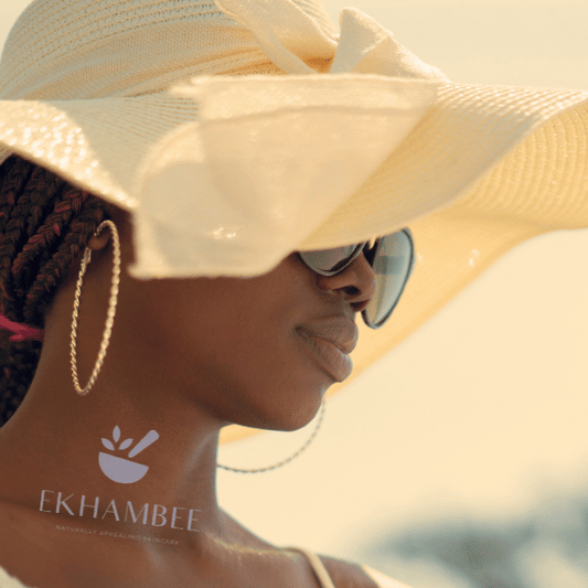 Image of a black woman with radiant skin wearing a large sun hat for sun protection