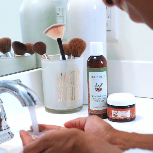 Pores and Blackhead Clarifying | Pores Minimizing Bundle | Ekhambee mud mask and toner gel on bathroom sink with smiling Black person running water on hands